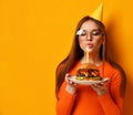 Woman hands hold big burger barbeque sandwich with beef and lit candle for birthday party on yellow Royalty Free Stock Photo