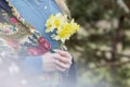 Woman hands hold daffodils, connection with nature, self-exploration concept, mindfulness