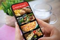 woman hands hold phone with food delivery app in ?afe