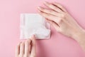 Woman hands hold sanitary pad on a pink background Royalty Free Stock Photo