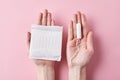 Woman hands hold sanitary pad and tampon on a pink background Royalty Free Stock Photo