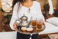 Woman hands hold silver tray with moroccan mint tea, cookies and vintage teapot Royalty Free Stock Photo