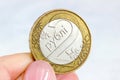 Woman hands holding Belarusian two rubles coin on light background close up.