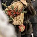 Woman hands holding bouquet of red ilex verticillata, winterberry for Christmas decoration Royalty Free Stock Photo