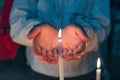 Woman hands holding burning candle Royalty Free Stock Photo