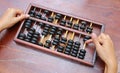 Woman hands holding Chinese ABACUS old antique calculator retro finance education, tool work business accounting Royalty Free Stock Photo