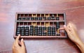 Woman hands holding Chinese ABACUS old antique calculator retro finance education, tool work business accounting Royalty Free Stock Photo