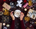 Woman hands holding coffee cup drink christmas holiday gift box on decorated festive table Royalty Free Stock Photo