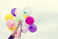 Woman hands holding colorful balloons on blue sky. Celebrate on summer party time. freedom concept Royalty Free Stock Photo