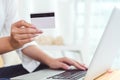 Woman hands holding credit card for online shopping or ordering product from internet when using laptop. Business and Payment Royalty Free Stock Photo
