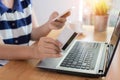 Woman hands holding credit card and using smart phone Royalty Free Stock Photo