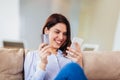 Woman hands holding a credit card and using smart phone for online shopping Royalty Free Stock Photo