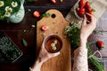 Woman hands holding cup of chamomile tea and strawberry. Summer atmospheric table with fresh strawberries, chamomile Royalty Free Stock Photo