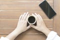 Woman hands holding a cup of hot coffee Royalty Free Stock Photo