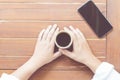 Woman hands holding a cup of hot coffee Royalty Free Stock Photo