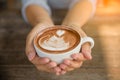 Woman hands holding cup of hot coffee latte cappuccino Royalty Free Stock Photo