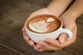 Woman hands holding cup of hot coffee latte cappuccino Royalty Free Stock Photo