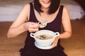 Woman hands holding and eating mush or boiled rice,Healthy breakfast in the morning,Enjoys of resting time Royalty Free Stock Photo