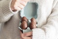 Woman hands holding egg carton with edible easter chocolate eggs inside Royalty Free Stock Photo