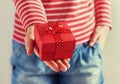 Woman hands holding a gift or present box with bow of red ribbon Royalty Free Stock Photo