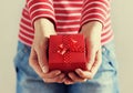 Woman hands holding a gift or present box with bow of red ribbon Royalty Free Stock Photo