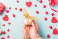 Woman hands holding gift or present box decorated and red heart surprise Royalty Free Stock Photo