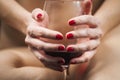 Woman hands holding a glass of wine