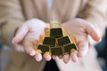 Woman hands holding gold bars stack as secure investment Royalty Free Stock Photo