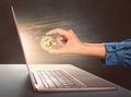 Woman hands holding golden bitcoin in front of a laptop Royalty Free Stock Photo