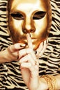 Woman hands holding golden carnival mask, rich luxury manicure a Royalty Free Stock Photo