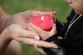 Red burning candle holding the hands of a child. Earth Hour. A child with a candle Royalty Free Stock Photo