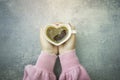 Woman hands holding heart shape cup of coffee Royalty Free Stock Photo