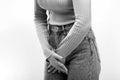 Woman Hands Holding Her Crotch. Sick woman hands holding pressing her crotch lower abdomen. Black and white Royalty Free Stock Photo