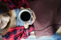 Woman hands holding hot coffee cup in bed, top view.Asian girl with cup of coffee or tea in bed at home early in the morning Royalty Free Stock Photo