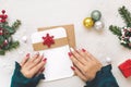 Woman hands holding a letter over festive table with various items