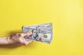 Woman hands holding money on yellow background Royalty Free Stock Photo