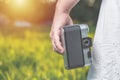 Woman hands are holding old vintage film camera outdoors. Toned. Royalty Free Stock Photo