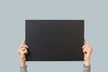 Woman hands holding olding a blank black paper