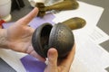 Woman hands holding part of banned cluster bomb