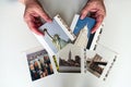 Woman hands holding photo prints of New York City isolated on white background.