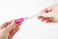 Woman hands holding positive pregnancy test