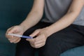 Woman hands holding pregnancy test when sitting on the sofa Royalty Free Stock Photo