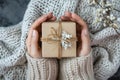 Woman hands holding present box with beige bow Royalty Free Stock Photo