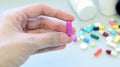 Woman hands holding a purple capsule of Clindamycin, used to treat bacterial infections, or treat patients who have an allergic. Royalty Free Stock Photo