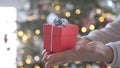 Woman hands holding red gift box presents with silver ribbon bow. Concept Season of giving, Christmas, happy new year Royalty Free Stock Photo