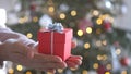 Woman hands holding red gift box presents with silver ribbon bow. Concept Season of giving, Christmas, happy new year Royalty Free Stock Photo