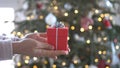 Woman hands holding red gift box presents with silver ribbon bow. Concept Season of giving, Christmas, happy new year Royalty Free Stock Photo