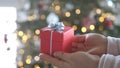 Woman hands holding red gift box presents with silver ribbon bow. Concept Season of giving, Christmas, happy new year Royalty Free Stock Photo