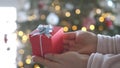 Woman hands holding red gift box presents with silver ribbon bow. Concept Season of giving, Christmas, happy new year Royalty Free Stock Photo