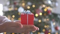 Woman hands holding red gift box presents with silver ribbon bow. Concept Season of giving, Christmas, happy new year Royalty Free Stock Photo